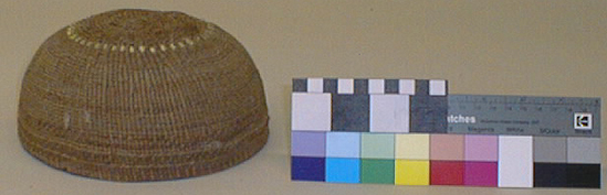 Hearst Museum object titled Basketry cap, accession number 1-87101, described as Work cap. Maily plain twining. 3 strand twining continues from start to where the first zone divider of 3 strand would normally occur. Two encircling bands of yellowish white overlay 4 cm. from start. Near rim is extra single row of 3 strand twining. Plain twining.  Conifer root, white grass.