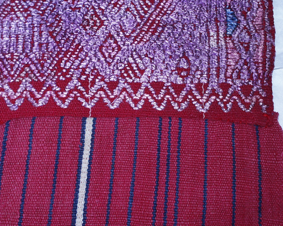 Hearst Museum object titled Tzute, accession number 3-29644, described as Tzute: Backstrap-loomed, warp predominant plain weave. Two-faced suppl. weft brocading. Two pieces joined by randa. End selvedges hemmed by hand-stitching. 8 1/2" silk floss tassels at each corner.