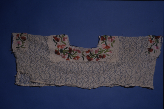 Hearst Museum object titled Blouse, accession number 3-29592, described as Huipil- Casamiento: Lace, commercial cotton, 1 piece. Ends hand stitched; head hole cut out and faced with manta, also sleeve openings. Embroidered with cotton whipping stitch. (25.5 cm X 63.5 cm). Context: short style; lace  German influence, from rural Coban, fiesta costume (Hun). Bottom could have worn out and been cut off. Olga Arriola de Geng Some wear, little rip at neck seam.