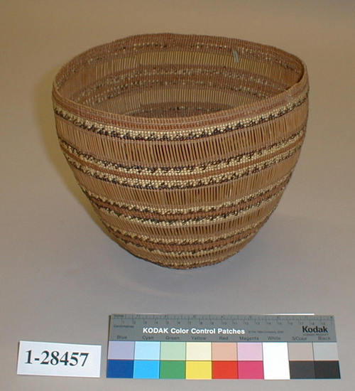 Hearst Museum object 1 of 2 titled Basket, accession number 1-28457, described as Twined, openwork bands; black, white, brown.  Tag: "Klamath R. Tribes att.". Per Ralph Shanks:  Close-twined and openwork basket, made for sale.  Crossed warp starting knot.  The warp material is probably willow.  The basket has conifer root wefts.  The overlay weft material is beargrass, maidenhair fern, and red-dyed woodwardia.  Starting at the starting knot, there are 2 inches of three strand twining interspersed with 2 weft rows of plain twining, followed by 1/8th inch of parallel warp openwork, followed by alternating bands of plain twining and parallel warp openwork.  Starting .5 inch from the rim, there is a single weft row of three strand twining, followed by 2 weft rows of plain twining, followed by another weft row of three strand twining, followed by 2 weft rows of plain twining.  The rim is trimmed.   The main design is a horizontal bands of red-dyed woodwardia outlined in either beargrass or maidenhair fern triangles.  The basket has a rightward work direction, with an up to the right slant of weft twist.  The overlay is single sided, with the design on the exterior.  The workface is on the exterior.  The basket is from Northwestern California.