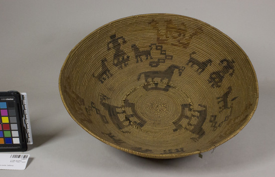 Hearst Museum object 3 of 3 titled Bowl basket, accession number 1-20911, described as Bowl basket; coiled. Warp is Epicampes (Sporobolus rigens), weft is Skunkbush (Rhus trilobata). Black color is Skunkbush dyed in Elderberry (Sambucus nigra). With representation of woman and animals.