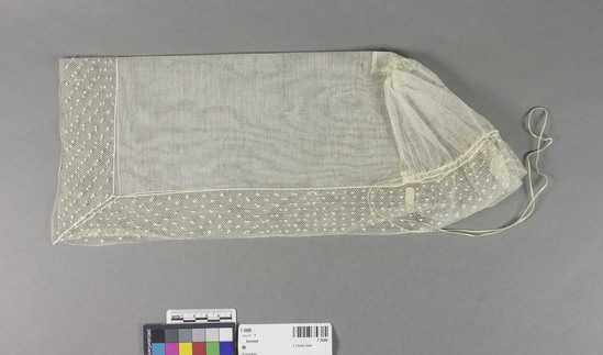 Hearst Museum object titled Bonnet, accession number 7-3680, described as Bonnet; cotton net; starched; white; dotted hexagonal mesh borders; braid ties; 6" x 16" when flat