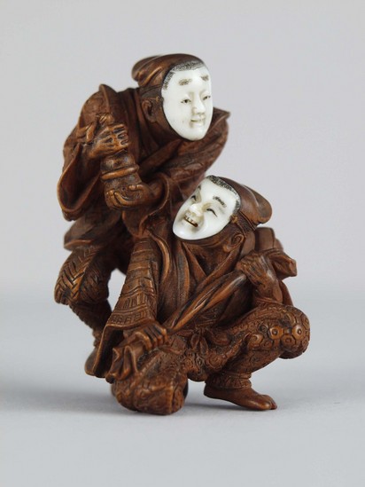 Hearst Museum object titled Netsuke, accession number 9-7897, described as Netsuke: two figures with soft caps. Ivory masks, much detail. Standing figure holds bell, kneeling holds cloth.