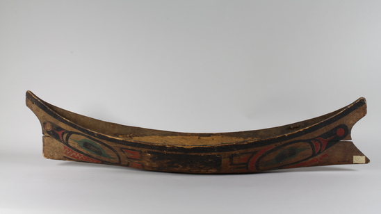 Hearst Museum object 5 of 6 titled Canoe model, accession number 2-10869, described as Model of canoe, painted totemic design in red, green, and black.  Wolf design (fide Charles Brown).