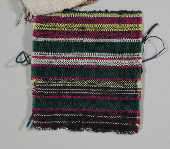 Hearst Museum object titled Textile fragment, accession number 5-11015, described as Textile sample (section of narrow band weaving). Multicolor stripes on weft of fine blue-black threads: white, maroon, magenta, green, yellow.