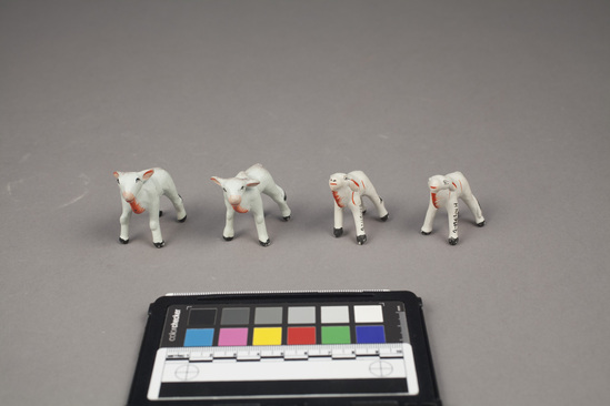 Hearst Museum object 2 of 5 titled Toy cows, accession number 9-11044a-h, described as Toy cows (8); painted clay;  large, each:  7 cm. length; 2 1/2 cm. width; small, each: 5 1/2 cm. length; 2 cm. width