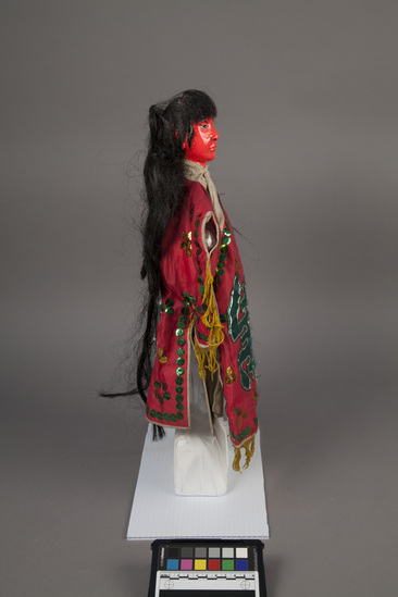 Hearst Museum object titled Hand puppet, accession number 9-22236, described as Puppet, hand.  Red Ghost  A. Head: carved wood, red with black features and hair  B. Body: white cloth, blue cloth legs. Boots:  wood, black and white.  C. Robe: red cloth with green sequins, yellow fringe, green character, "Shou" on front and back 39 x 28 cm (15 3/8 x 11 in)