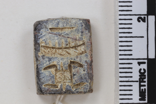 Hearst Museum object titled Seal, accession number 5-7408, described as Seal. Rectangular two sided seal. Purple stain on surface. Obverse-Thoth with maat feathers. Reverse-hieroglyph includes turtle. Length 1.73 cm. Width 1.32 cm. Height 7 mm.  Anubis ? maaat feather and two signs above feather - really strange - almost like t3wy