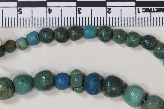 Hearst Museum object titled Beads, accession number 6-13475, described as String blue glaze spherical (ball) beads; length 39 cm, piece count: 45+.