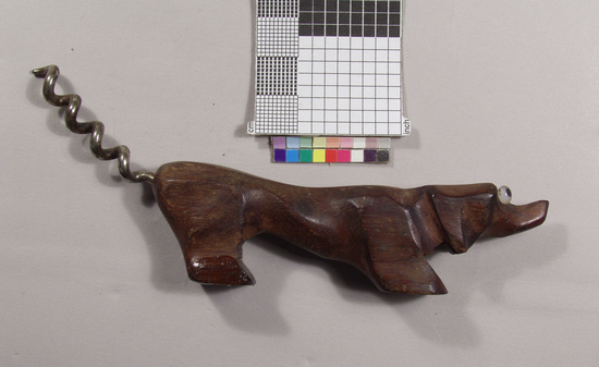 Hearst Museum object titled Corkscrew, accession number 2-69018, described as Corkscrew, straight handle, zoomorphic; walnut handle in shape of a dachshund with plastic eyes; nickel plated steel helical wire work; 13.8 cm long.