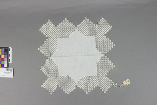 Hearst Museum object titled Textile sample, accession number 7-7067, described as Handkerchief?  Linen.  Plain weave, wide drawn work borders.  White.  10½ inches by 10½ inches irregular.