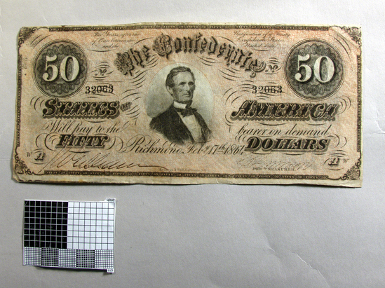 Hearst Museum object titled Paper money: 50 dollar, accession number 2-45253, described as (Confederate States currency); $50, reddish network background, Jefferson Davis, serial letter WA, serial # 32063, reverse has intricate blue engraving with “Fifty” in large letters