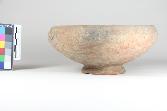 Hearst Museum object titled Cup, accession number 8-1561, described as Cup, low corded foot. Description from Matteucig (1951): Bowl; height: 7.2 cm; diameter: 16.2 cm (see Matteucig's plate IV, 24). Red impasto. Clay heavy cream; polished reddish surface with black shiny particles. Lip turned inside; rounded sides contracting to ring base. Small part of lip chipped off.  Cf. Not. Sc., 1906, p. 67, fig. 10 c, from Bolsena.