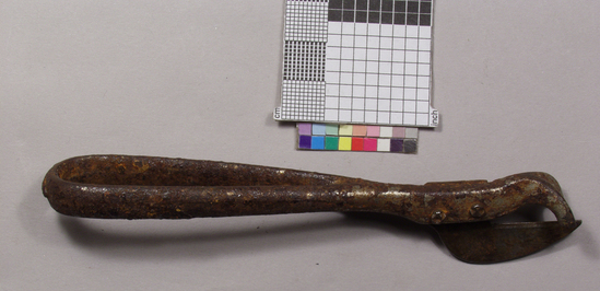 Hearst Museum object titled Can opener, accession number 2-68869, described as Can opener; nickel plated cast iron handle, shaped to fit palm, open at center rusted; steel cutting knife riveted to handle; 13.5 cm long