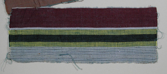 Hearst Museum object titled Textile sample, accession number 5-11193, described as textile sample (section of narrow band weaving):  one side of maroon; other side of pale blue and black lines; center; black flanked by yellow and green alternating stripes;  l. 23.6 x w. 9 cms.