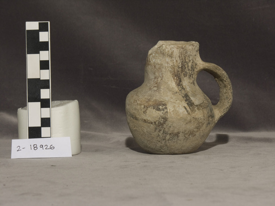 Hearst Museum object titled Pitcher, accession number 2-18926, described as Small pottery, with handle; paint black or white, part of rim missing.