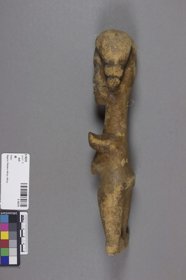 Hearst Museum object titled Doll, accession number 5-16315, described as female doll, carved, short stumpy arms, prominent navel. Conservation: One arm broken, both feet broken, one braid end broken.