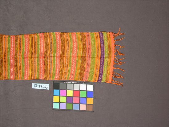 Hearst Museum object titled Sling, accession number 18-1226, described as Shoulder cloth, women’s. Orange, green, yellow, white, and purple horizontal stripes. Fringed. Orange warp threads. Width 34 cm. Length 123 cm. (excluding fringe).