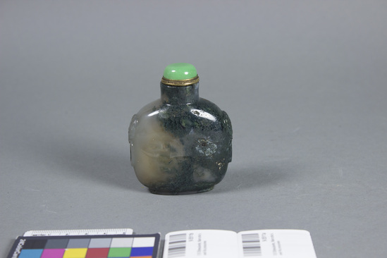 Hearst Museum object titled Snuff bottle, accession number 9-5511a,b, described as Snuff bottle; green moss agate; bottle has simulated handles carved on sides; green stone and gold stopper; ivory dipper; height 3 1/8 in