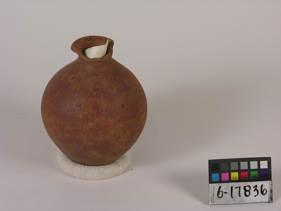 Hearst Museum object titled Broken bottle, accession number 6-17836, described as Pottery: maroon bottle, polished, worn, rim broken; least diameter 5 cm, greatest diameter 12 1/2 cm, height 17 cm.