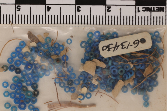 Hearst Museum object 3 of 3 titled Beads, accession number 6-13430, described as Beads: very small blue discs (rings) on original string; mass of small blue discs, piece count: 100+.